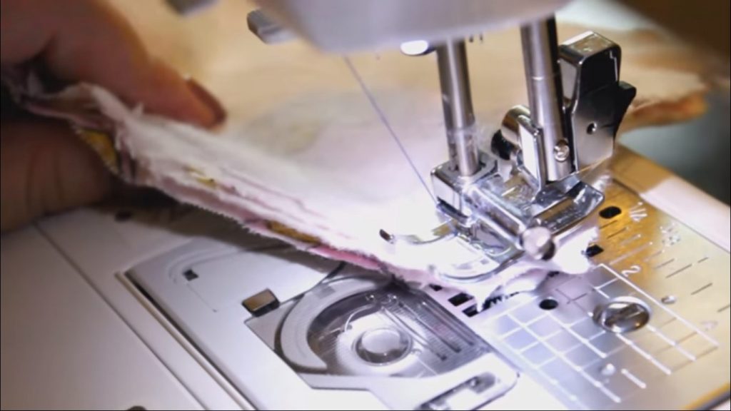 machine needle threading the clothe