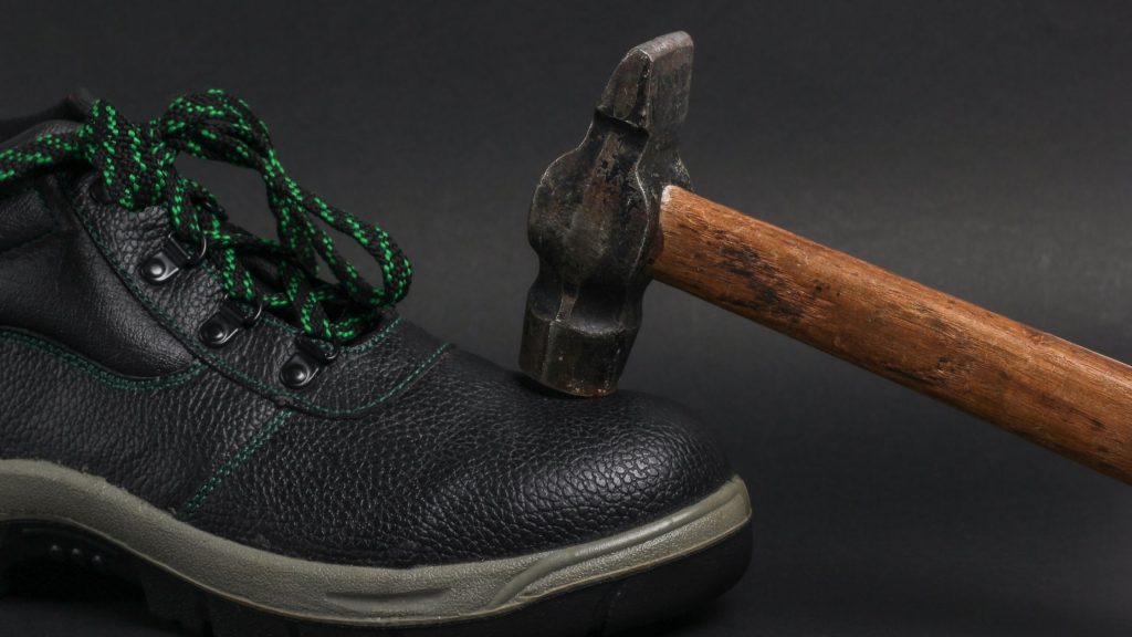 a hammer on a leather shoes stating strength and longevity